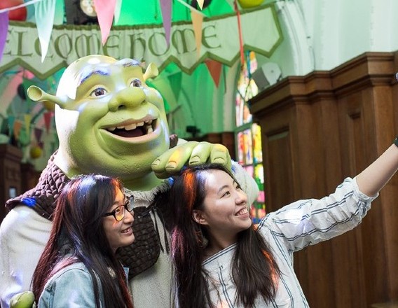Visitors posing with Shrek at Shrek's Adventure London
