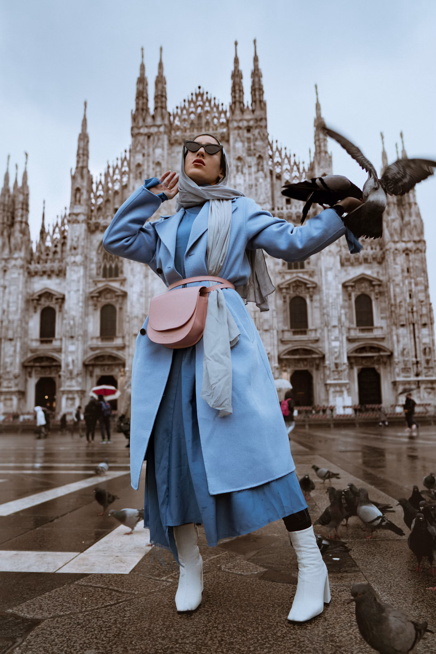 Fashion model posing in a city setting in a dark evening look