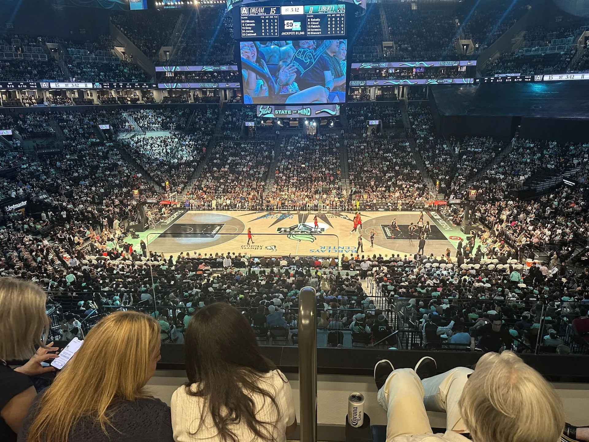 Basketball game action with fans watching from arena seats