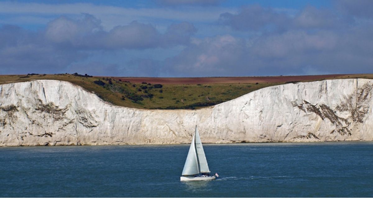 Sailboat passing the white cliffs of Dover