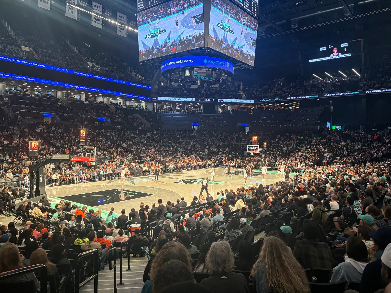 Spectators following a Liberty game from the stands