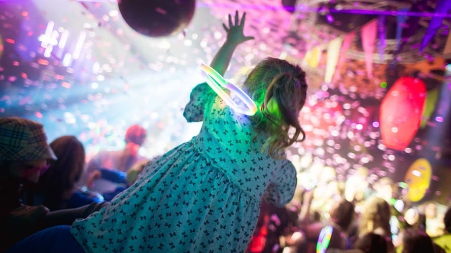 Child at a colourful live concert