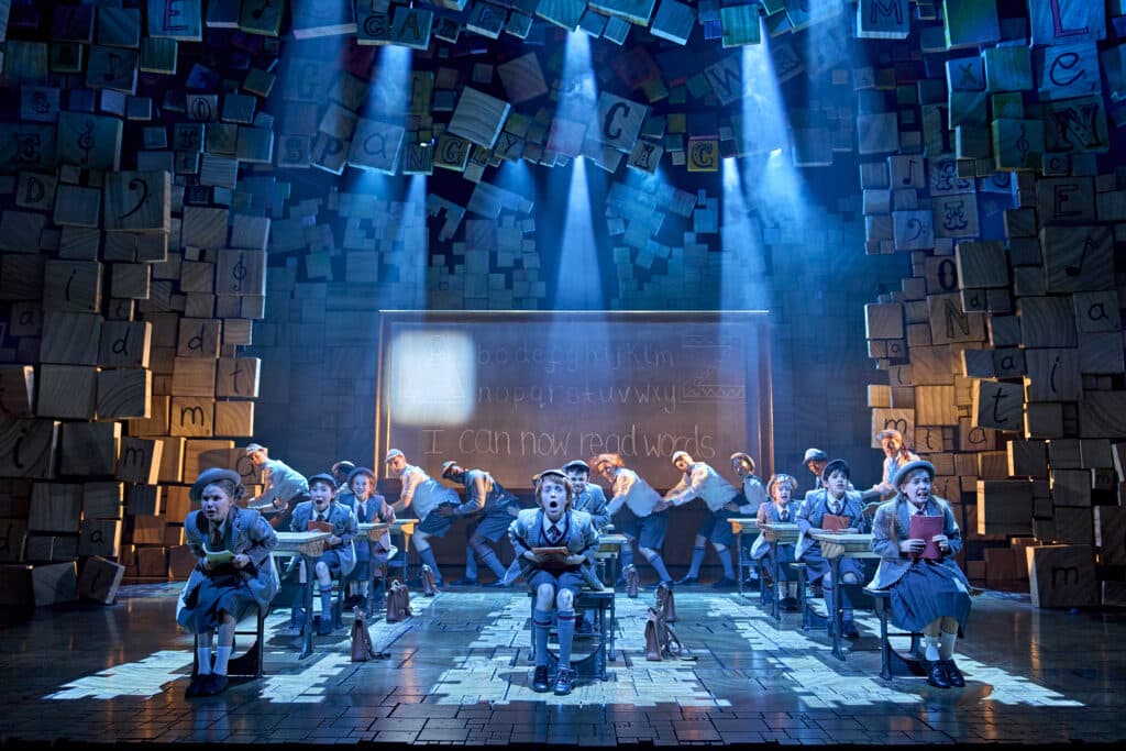 Matilda company performing at the Cambridge Theatre