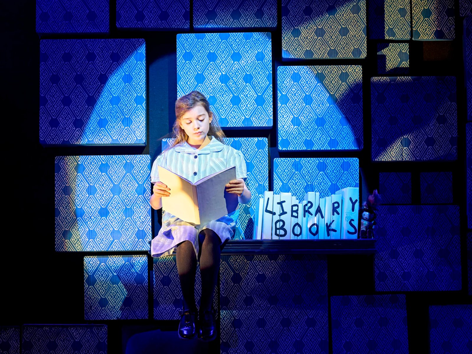 Matilda performers on stage during a musical number