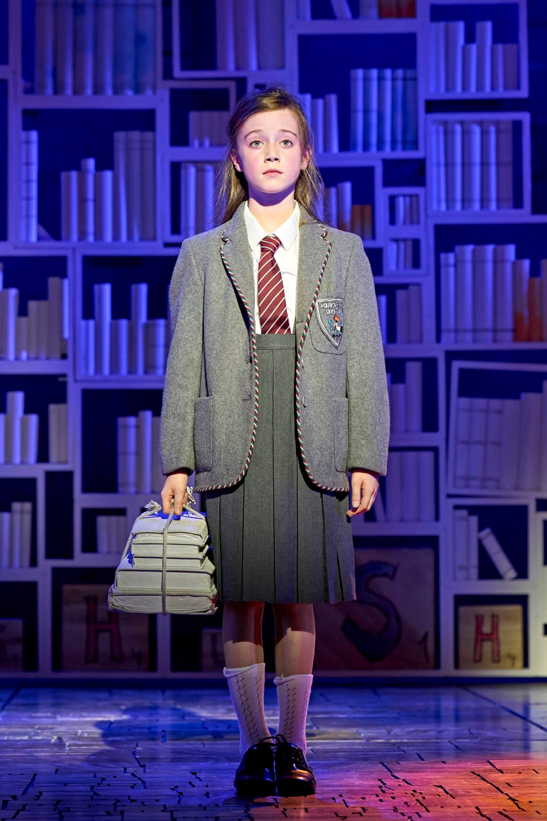 Matilda performer and cast in a theatrical scene