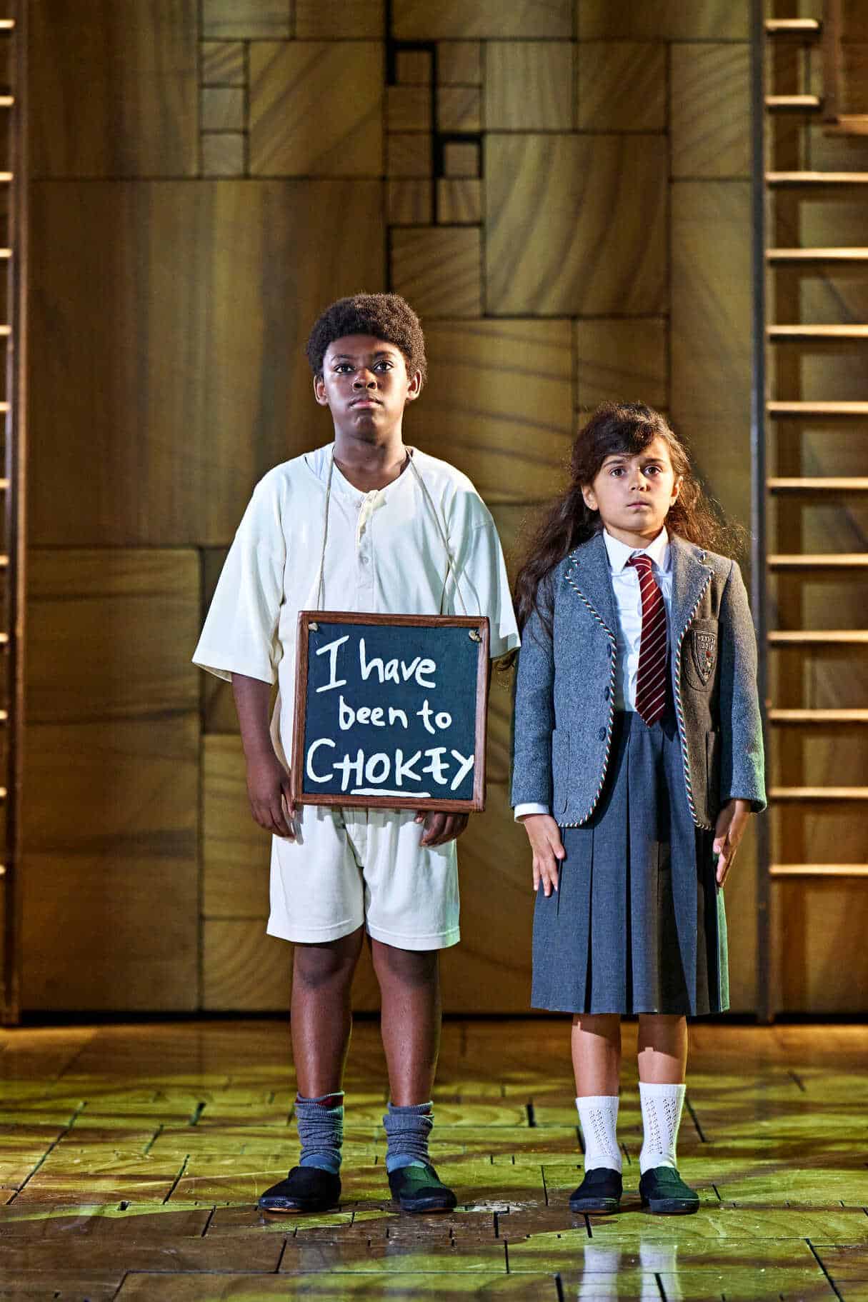 Two young performers sharing a stage scene