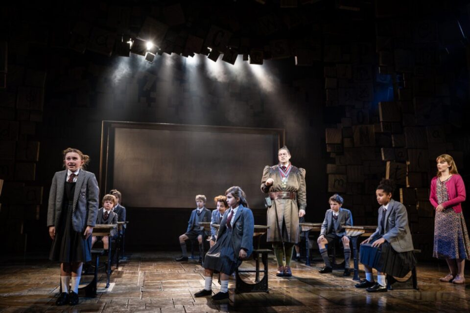 Matilda cast performing on the Cambridge Theatre stage