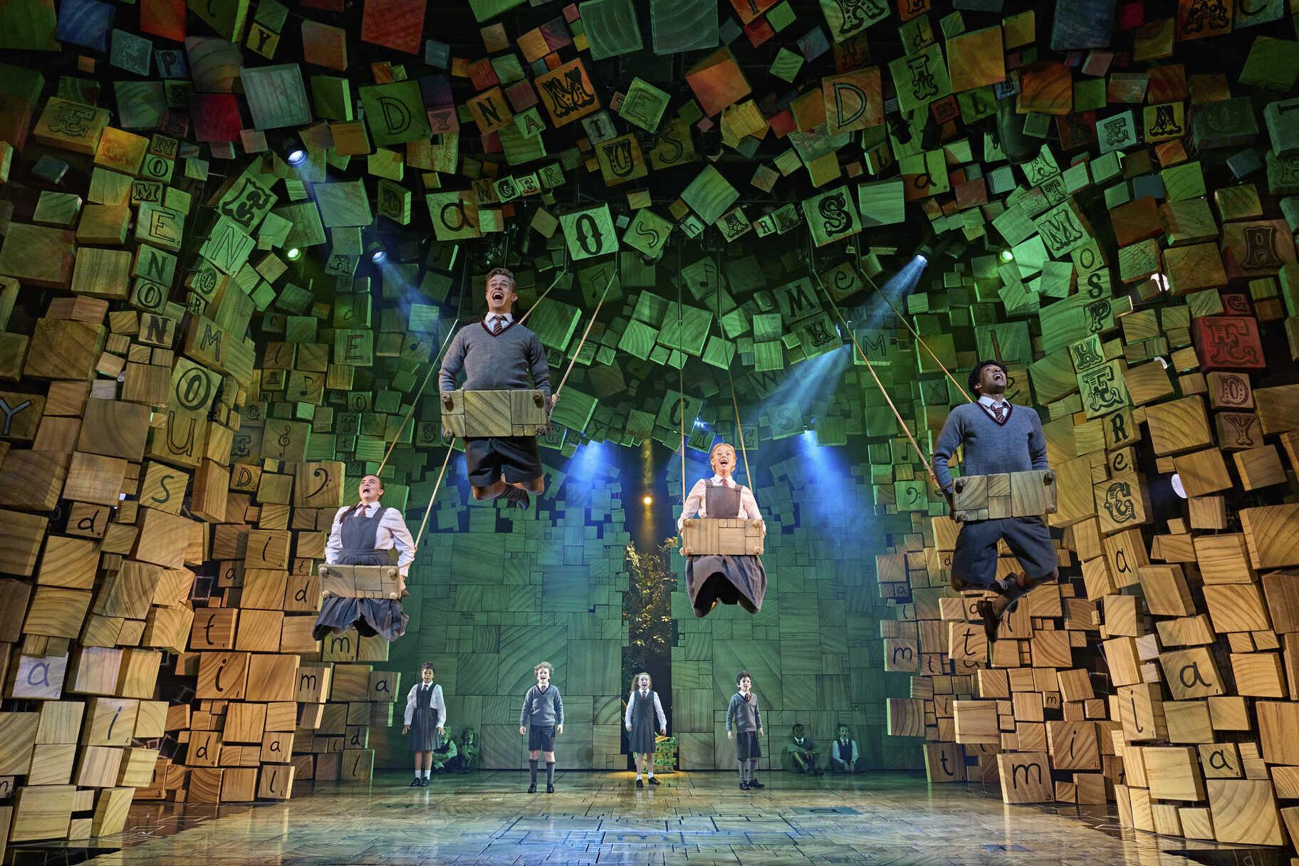 Young performers in a schoolroom scene from Matilda The Musical