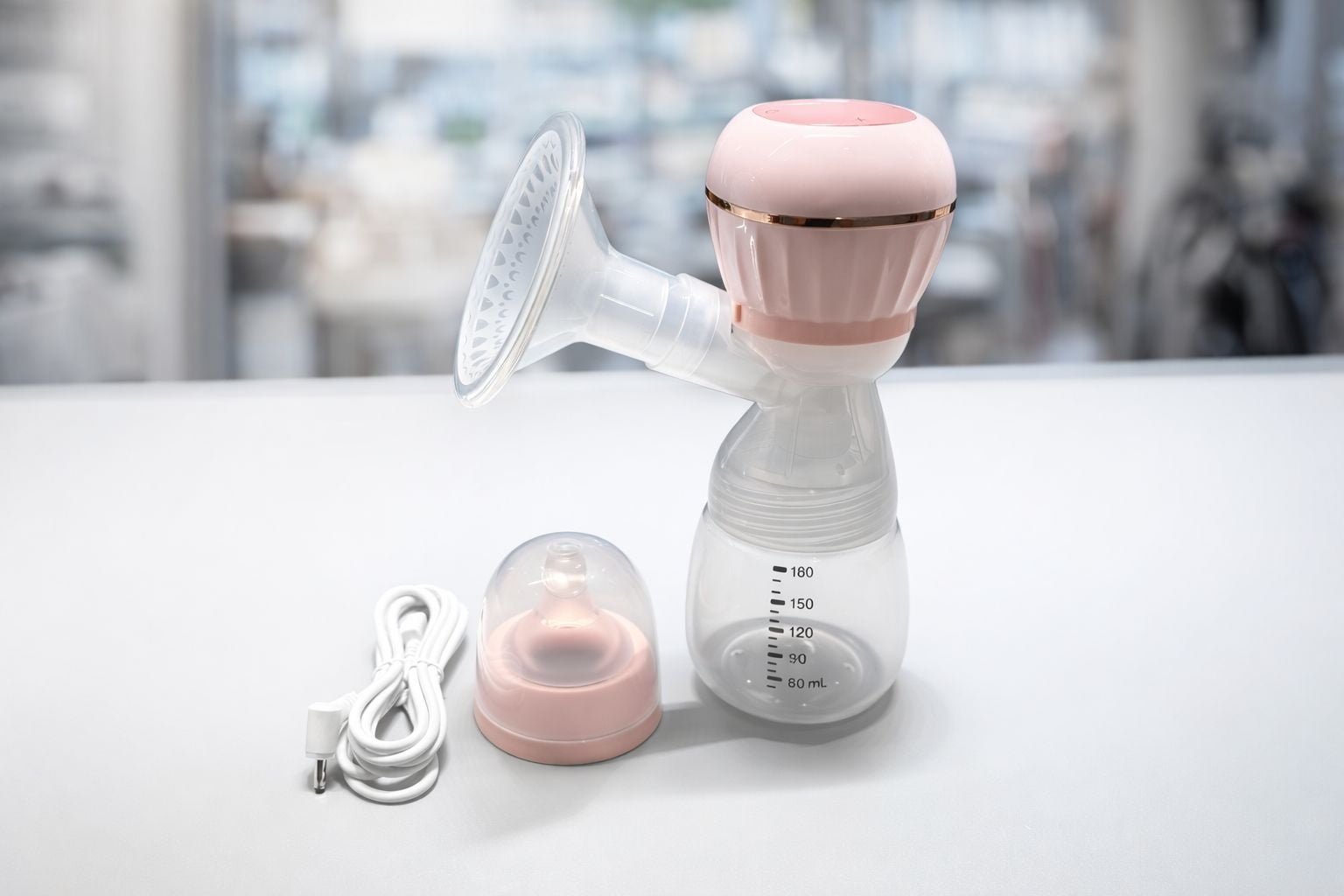 Mini electric breast pump with bottle and controls