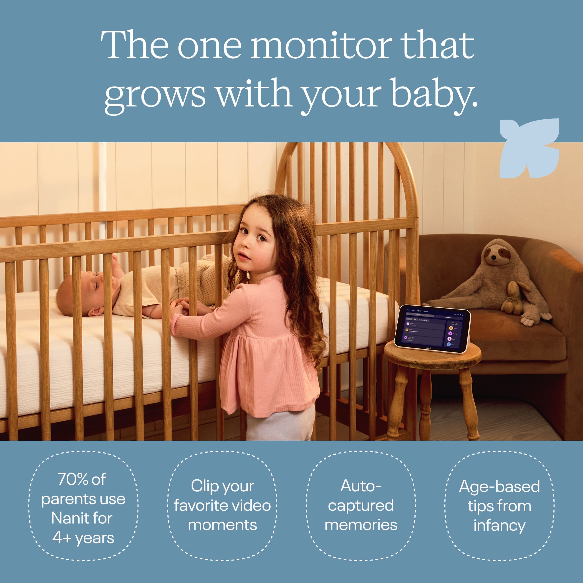 Young child standing beside a crib while a baby rests inside