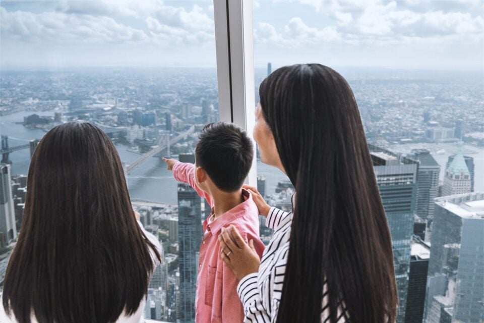 Visitors looking out from One World Observatory observation level
