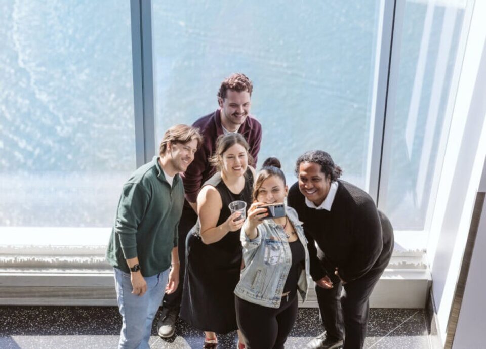 Group taking a selfie indoors at One World Observatory