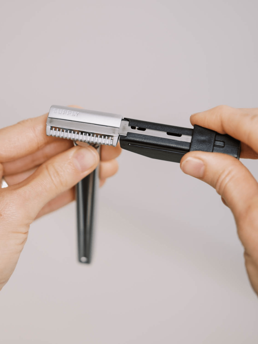 A blade being loaded into a Supply single-edge razor