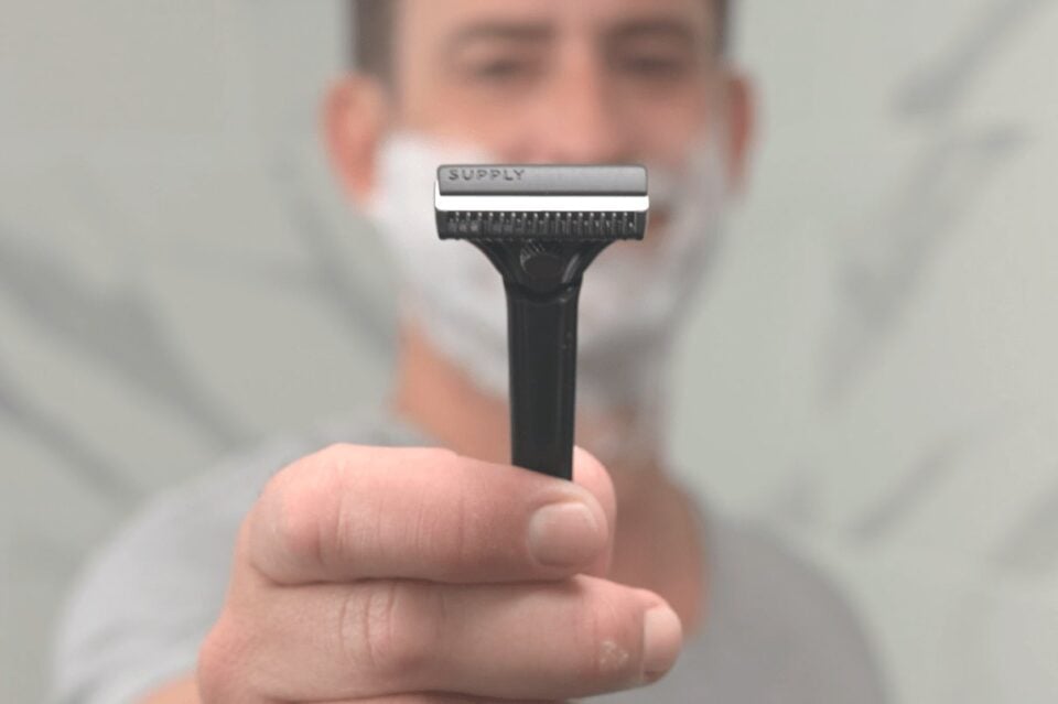 A person holding the Supply Single Edge SE razor