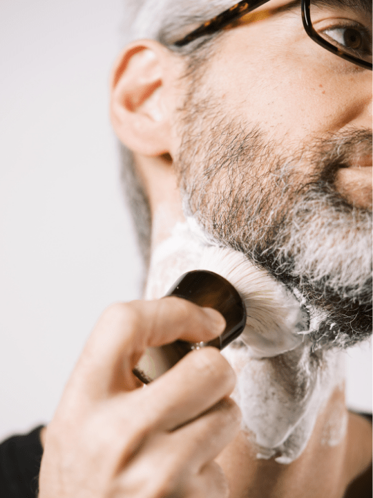 A man applying shaving cream