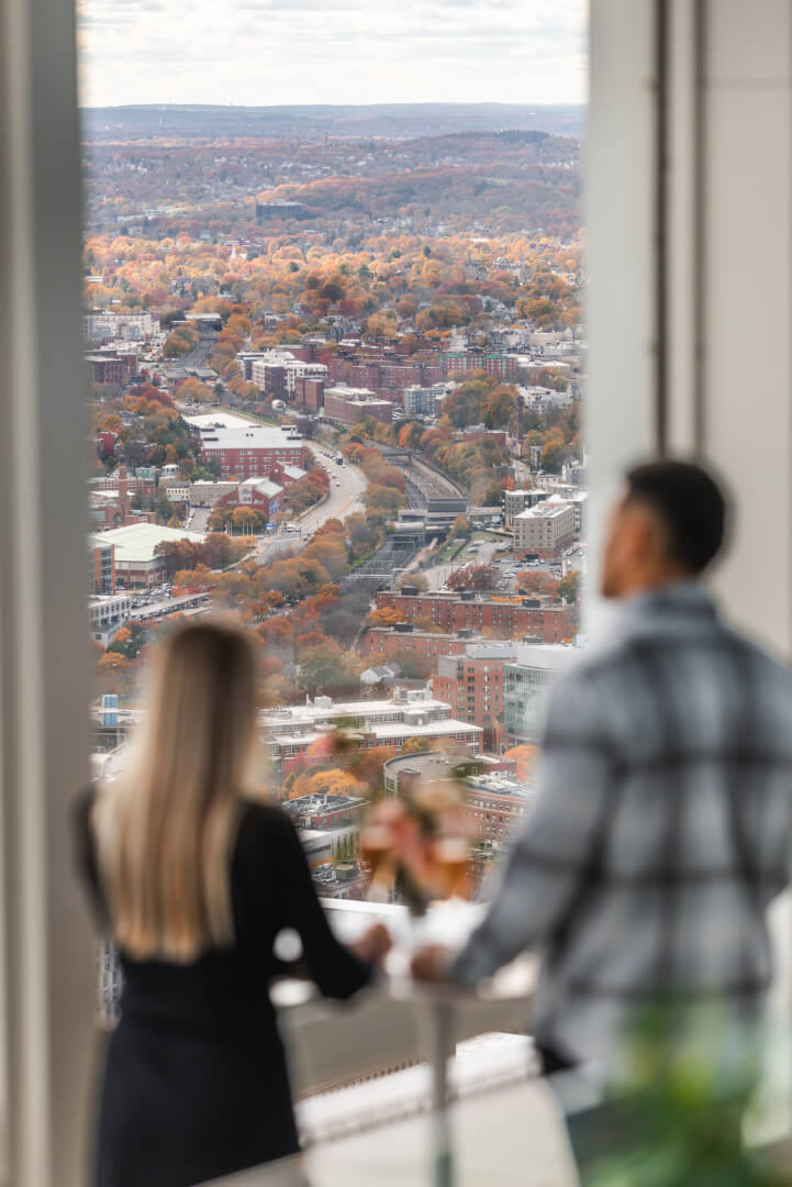 People overlooking an autumn cityscape from View Boston