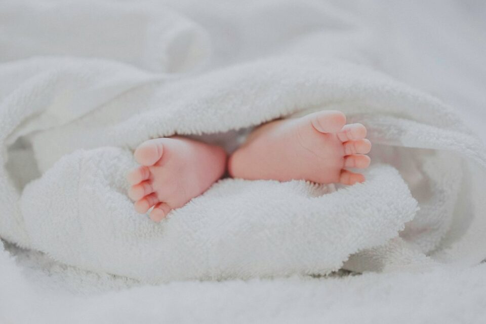 Baby feet under a blanket