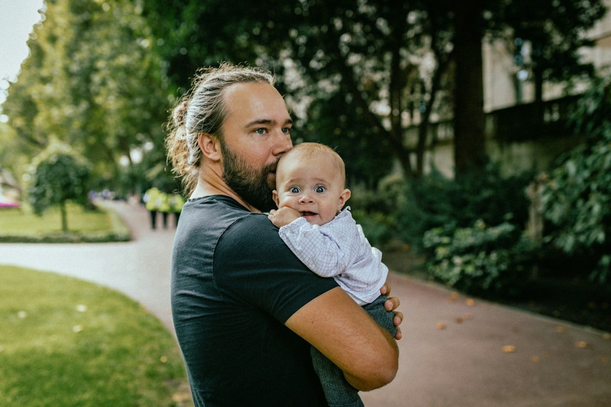 Father carrying a baby outdoors