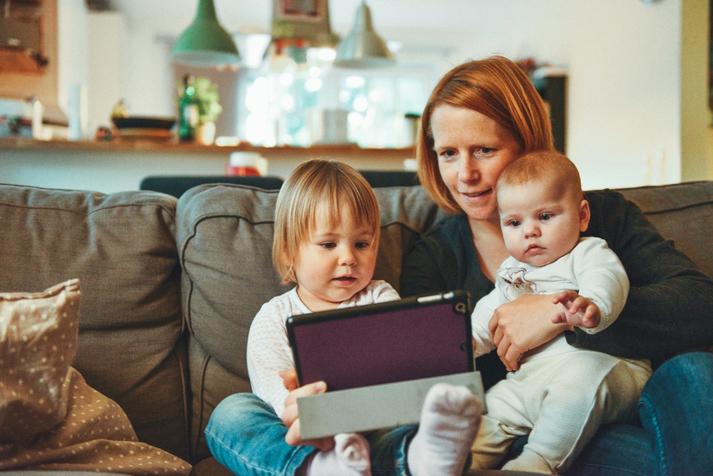 Parent and children using a tablet